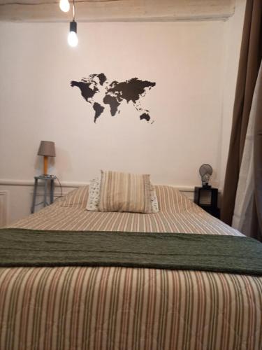 a bedroom with a bed with a map on the wall at Charmant studio dans le Vieux Tours in Tours