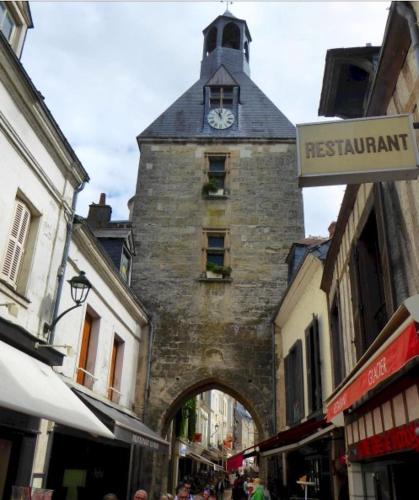 a building with a clock tower on top of it at Côte du Jardin in Pouillé