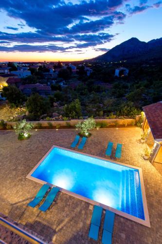 a swimming pool on the roof of a house at Villa Grandioza in Seline