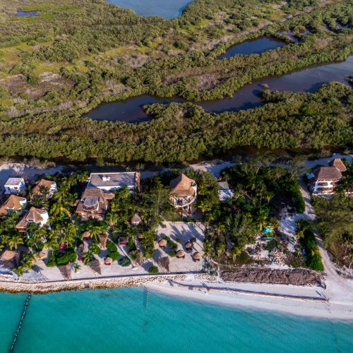 an aerial view of a resort on the water at Hotel Villas Flamingos in Holbox Island