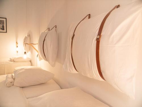 a room with white towels hanging on a wall at Lisbon Top Hostel in Lisbon