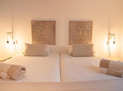 two beds in a room with white sheets and towels at Lisbon Top Hostel in Lisbon