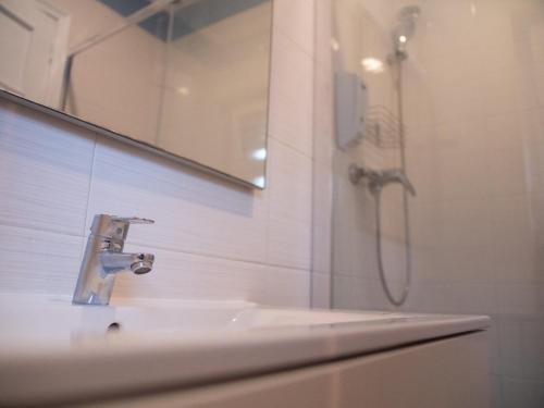 a bathroom with a sink and a shower at Lisbon Top Hostel in Lisbon
