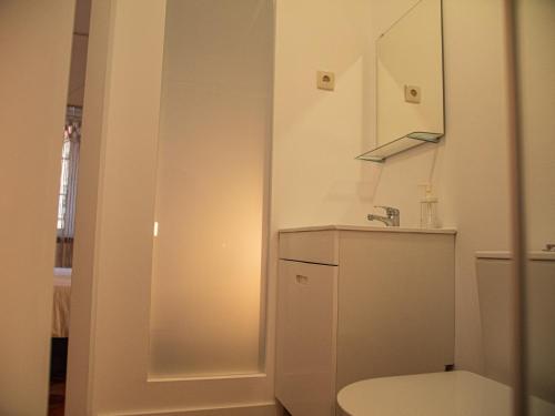 a bathroom with a toilet and a sink and a mirror at Lisbon Top Hostel in Lisbon