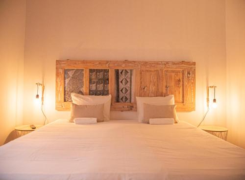 a bedroom with a large white bed with wooden cabinets at Lisbon Top Hostel in Lisbon