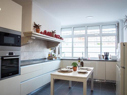 a kitchen with a stove, sink, and dishwasher at Lisbon Top Hostel in Lisbon