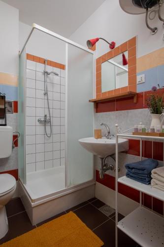 a bathroom with a shower and a sink at Beach front Apartment in Podgora