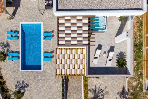 an overhead view of a swimming pool and a resort at Villa Grandioza in Seline