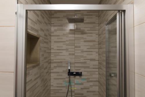 a shower with a glass door in a bathroom at AgrellaMar - by TonsdeVerde in Braga