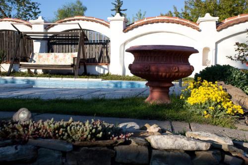 a garden with a large vase in a yard at Lichtenstein LVA Apartmán in Břeclav