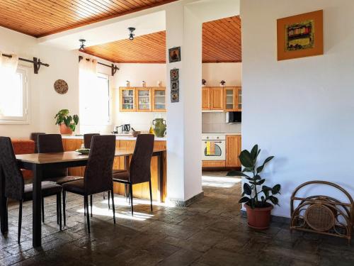 a kitchen and dining room with a table and chairs at Katouni Bridge Villa in Kythira