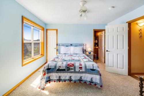 a bedroom with a bed and a window at Spacious Seaside Home with an Ocean View in Seaside