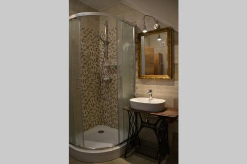 a bathroom with a sink and a shower at Villam Apartment in Maribor