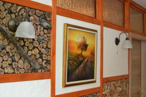 a painting of a tree on a wall at Villam Apartment in Maribor