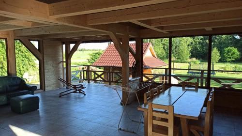 a large room with a large table and chairs at Dom Królewski Róg in Giżycko
