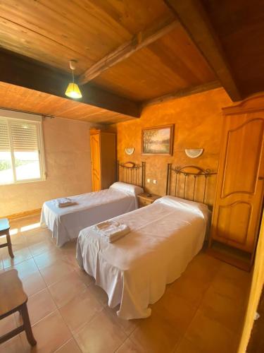 מיטה או מיטות בחדר ב-Posada del Cid