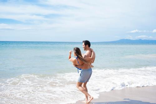 a man and a woman standing on the beach at Casa Doña Susana in Puerto Vallarta