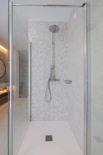 a shower with a glass door in a bathroom at Hotel Vouga in Termas de Sao Pedro do Sul