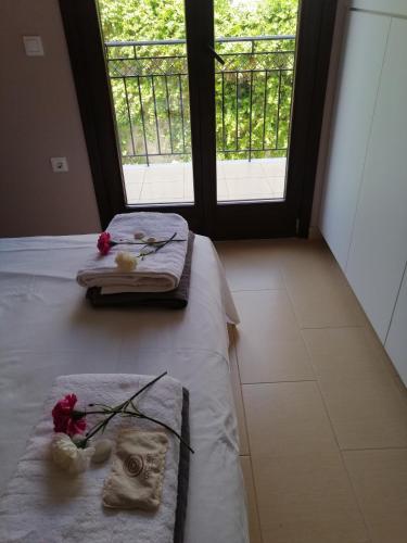 a bedroom with two twin beds and a window at Villa Clio in Mánganos