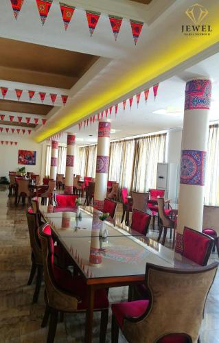 a large room with a long table and chairs at Jewel Matrouh Hotel in Marsa Matruh