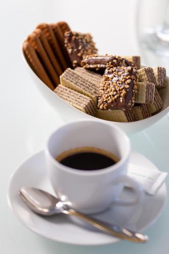 a cup of coffee and a plate of desserts at Villa Grandioza in Seline