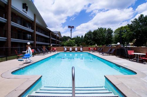 a swimming pool in front of a building at Brick Lodge Atlanta/Norcross in Norcross
