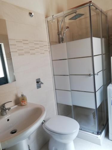 a bathroom with a shower and a toilet and a sink at Casa Concetta in Modica