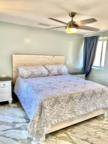 a bedroom with a bed and a ceiling fan at Beachfront Condo close Puerto Nuevo, Papas, and Valle de Guadalupe in Rosarito