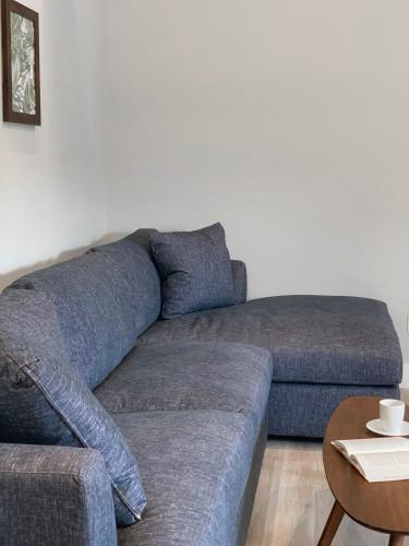 a living room with a blue couch and a table at A Wave Inn - Montauk in Montauk