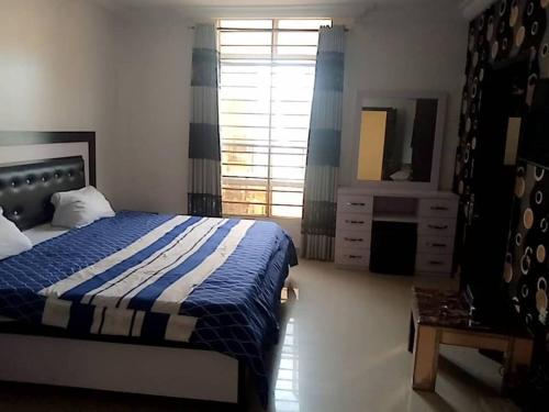 a bedroom with a bed and a dresser and a mirror at luxury 4 bed rooms duplex lekki Lagos nigeria in Lekki