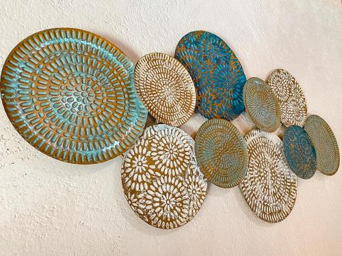 a group of plates hanging on a wall at Hotel Boutique Santo Cuervo in Bernal