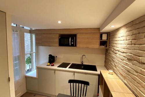 a small kitchen with a sink and a microwave at Studio Zen Tokyo in Lyon
