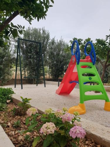 a playground with two swings and a swing at Apartment Sandra in Trogir