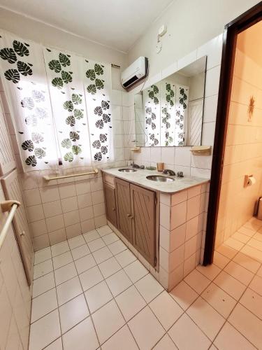 a bathroom with a sink and a mirror at Raíces Hostería Boutique in Sierra de la Ventana
