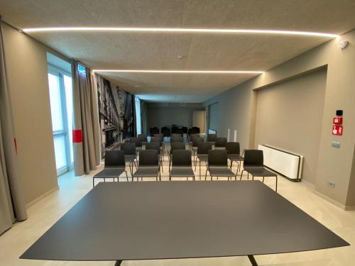 a conference room with a large table and chairs at Amedia Hotel Milan, Trademark Collection by Wyndham in Milan