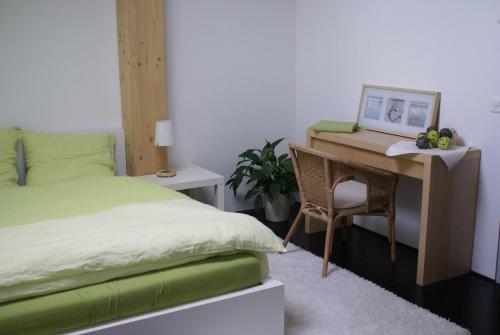 1 dormitorio con escritorio, cama y silla en Carpe Diem - Bnb - Chambres d'hôtes, en Péry