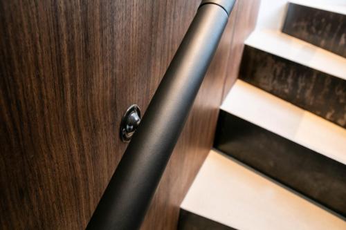 a wooden door with a metal door knob on a stairs at The Roebbek x Hanse in Hamburg