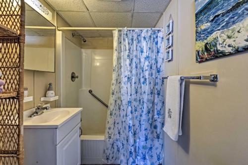 a bathroom with a shower curtain and a sink at Condo with Pool Access on Wildwood Crest Beach! in Wildwood Crest