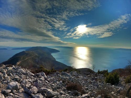 a view of the ocean from a rocky mountain at Tramuntana Holiday Home in Porozina
