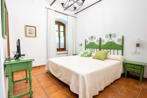 a bedroom with a bed and a television in it at Alojamiento Rural Molino Del Puente in Dúrcal