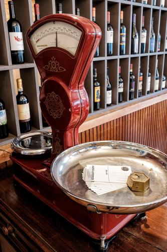 a red appliance on top of a table with bottles of wine at Albergo Cerchi in Tortona