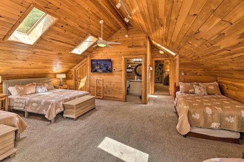 a bedroom with two beds in a wooden cabin at Kayaks and Fire Pit Lux Riverfront Lodge, Sleeps 20 in Rapid City