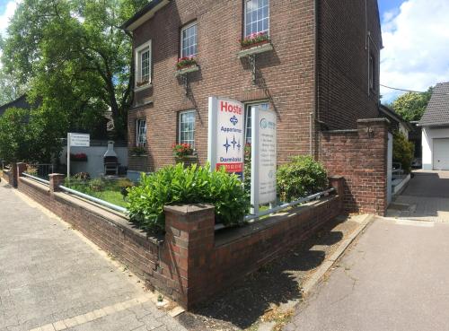 a brick building with a sign in front of it at Dormitorium Kaarst Wohnraum auf Zeit in Kaarst