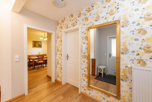 a hallway with a mirror and a dining room at Im alten Rathaus in Bad Liebenstein