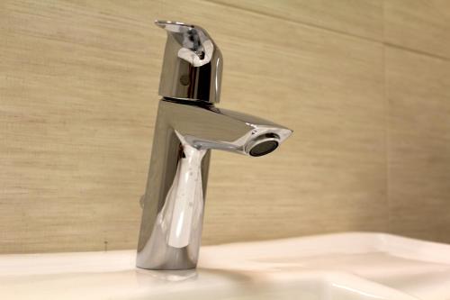 a silver faucet on a sink in a bathroom at Villa Bice in Pulsano