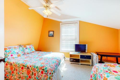 a bedroom with two beds and a flat screen tv at Driftwood Villa - 287 in Edisto Beach