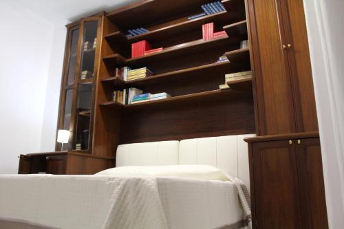 a bedroom with a bed and a book shelf at Villa Bice in Pulsano