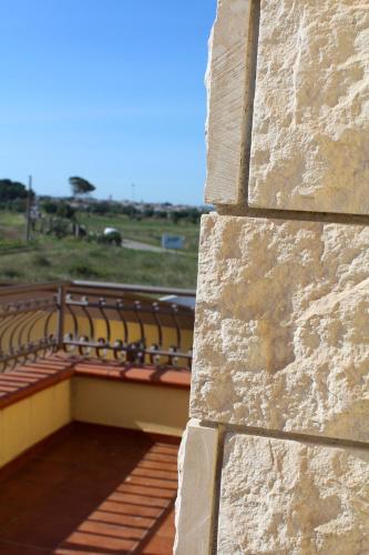 a brick wall with chairs on top of a building at Villa Bice in Pulsano