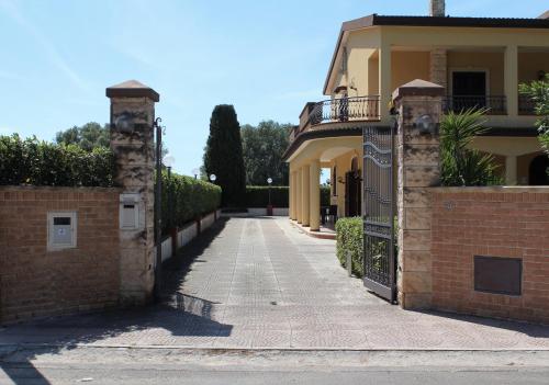 a house with a gate and a walkway at Villa Bice in Pulsano