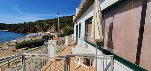 a balcony of a house with a view of a beach at Appartamenti Villa Miramare in Capoliveri